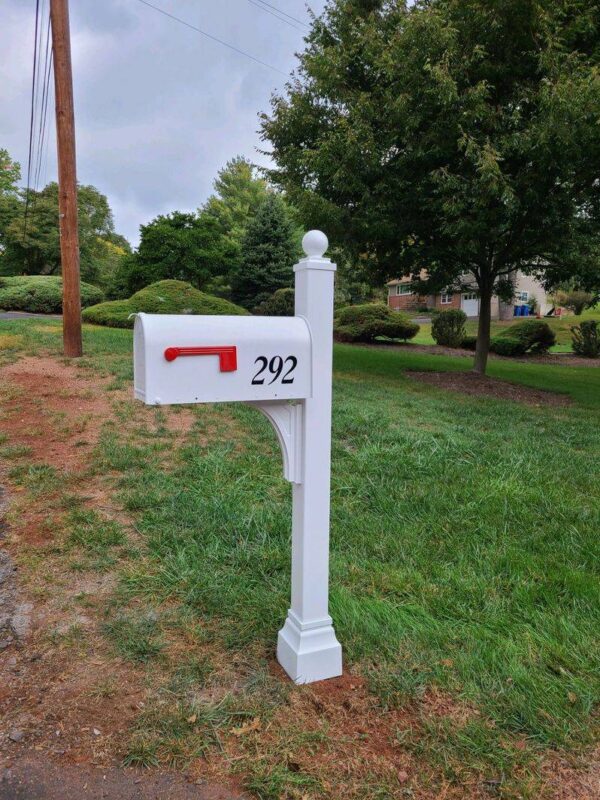 A Janzer Mailbox / Post Installation Package in a grassy area.