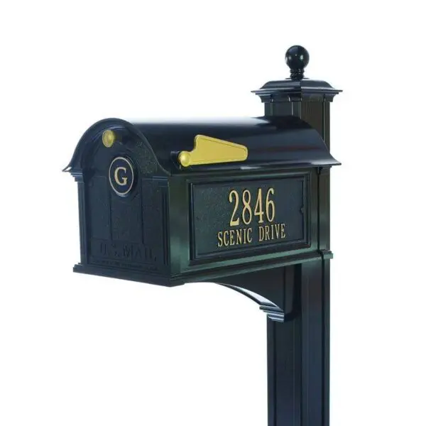 A black mailbox with gold lettering and a black mailbox post.