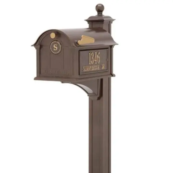 A bronze mailbox with a number on it.