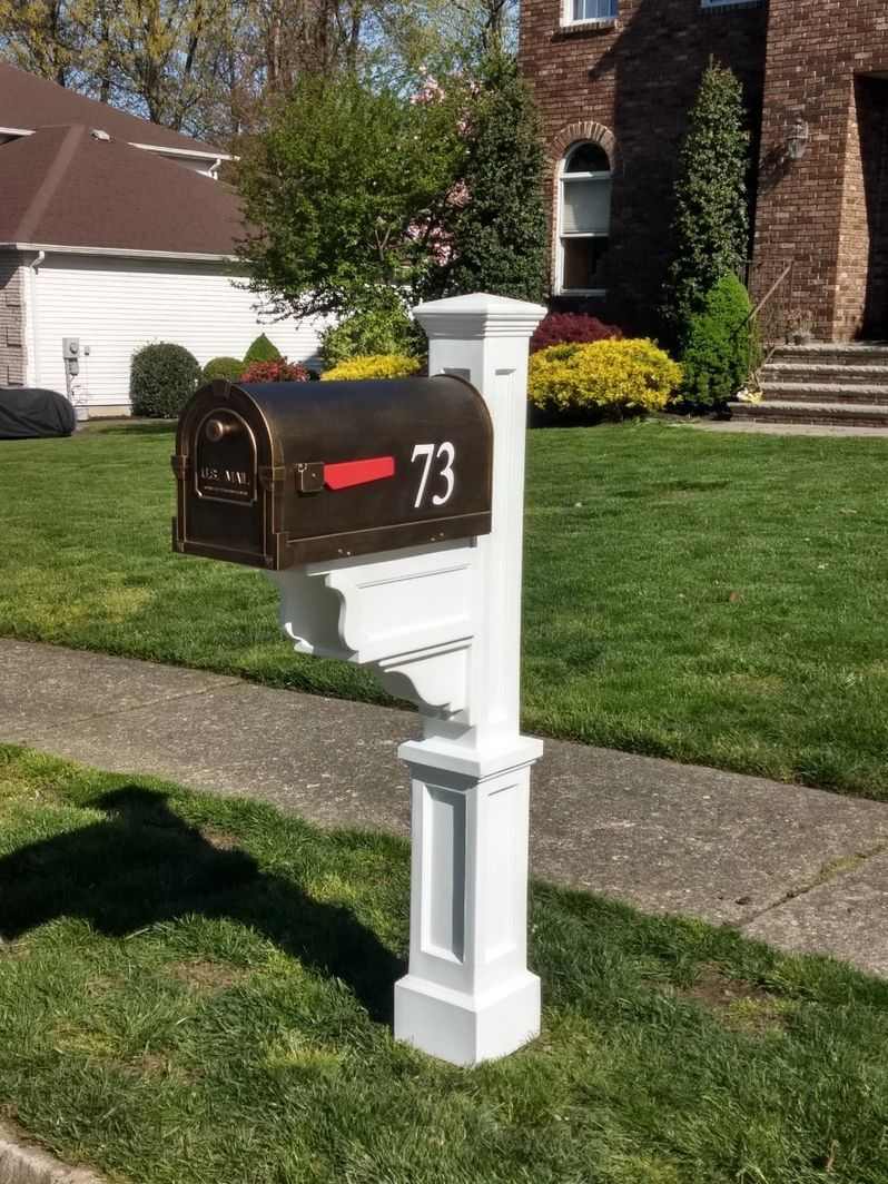 A Special Lite Savannah Mailbox And Mayne Dover Mail Post Installation Package with a mailbox pole in front of a house.