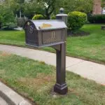 A mailbox in the middle of a grassy area.