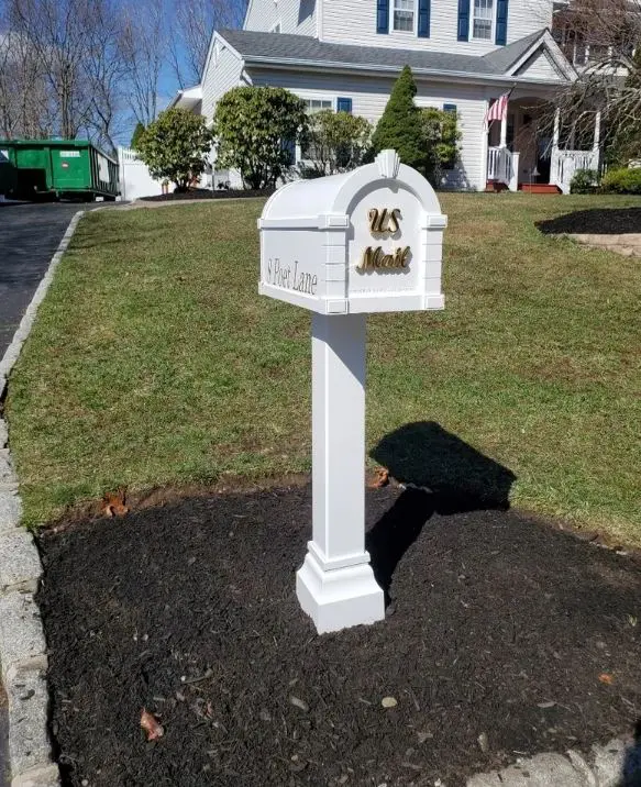 A Gaines Keystone Standard Installation Package mailbox in front of a house.