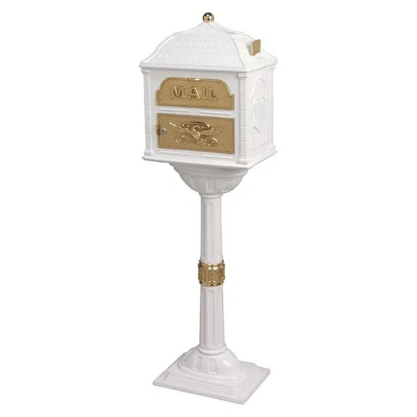 A Gaines Classic Mailbox with Polished Brass Accent - Installation Included on a pedestal with gold accents.