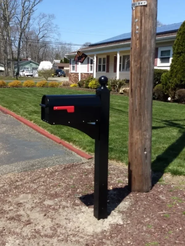 A Gibraltar Landover Mailbox Post with Sequoia Mailbox Installation Package on a pole in front of a house.