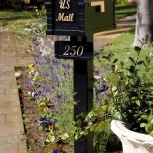 A black mailbox with a flower pot in front of it.