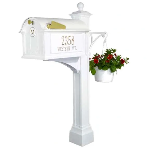 A white mailbox with a flower pot on it.