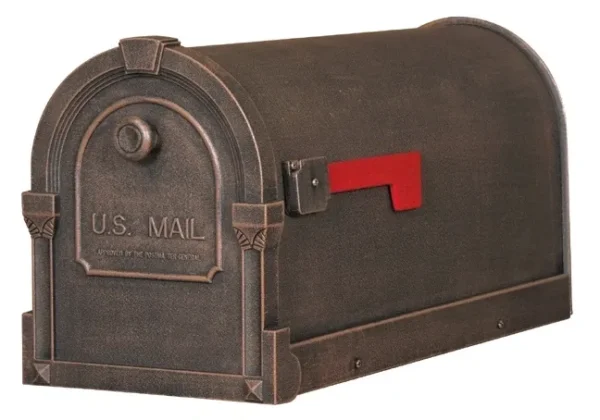 A bronze mailbox with a red handle.